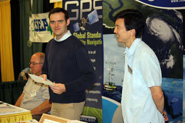 Three men working the NOAA booth at a science teacher conference