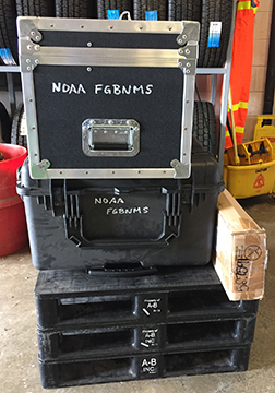End view of two cases stacked on top of three pallets. Each case is labeled NOAA FGBNMS