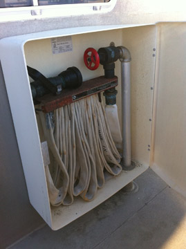 Fire hose coiled up in a cabinet