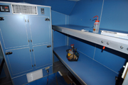 Sleeping quarters on the R/V Manta.  Blue lockers on the left are for storage.  Two blue shelves on the right are beds without mattresses.