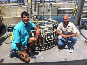 R/V MANTA Captains Mike and Darrell posing with a recovered camera array on the deck of the boat