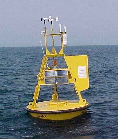 A bright yellow data buoy floating on the ocean
