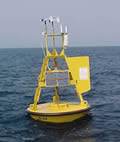 Yellow data buoy floating on top of the ocean.