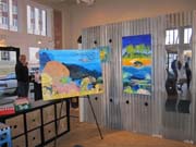 Colorful paintings of marine life on display in a shop.
