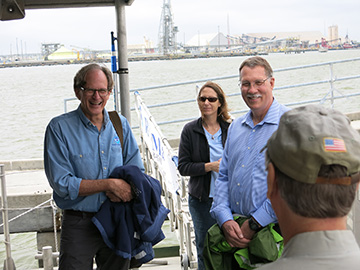 G.P. Schmahl and Russell Callender standing on the back deck of R/V MANTA after stepping off the gangway to board. Emma Hickerson is standing just behind them.