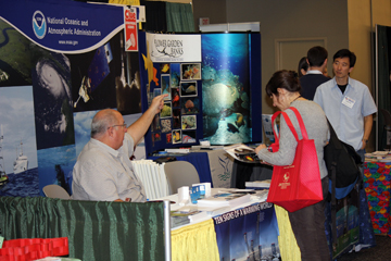People visiting the NOAA booth at a science teacher conference