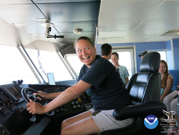 Teacher at the helm of R/V MANTA pretending to drive the boat