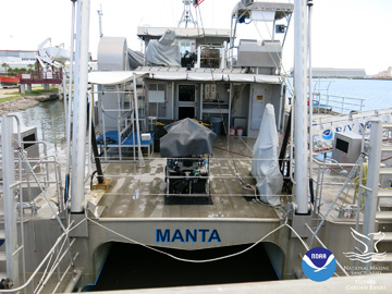 Stern of R/V MANTA with the ROV on deck under a tarp