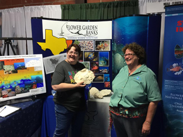 Shelley DuPuy (right) and her sister (left) standing in front of the sanctuary display booth