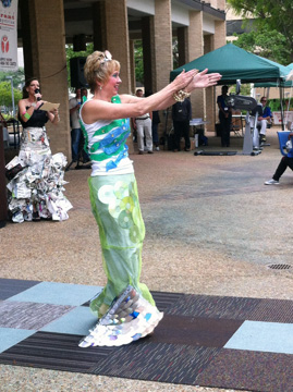 A woman dressed as a mermaid in a costume made from recycled CDs