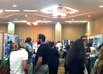 A crowd of people in a room displaying scientific posters