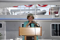Sylvia Earle standing at the speakers' dais with the Manta visible behind her.