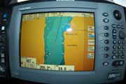 Data screen showing vessel coordinates and speed below a map of the area showing the vessel's physical location