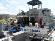 Students crossing the gangway from the dock onto the R/V Manta.