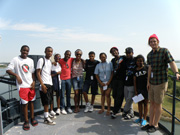 Group posing on an upper deck of Battleship Texas with the ship channel behind them.