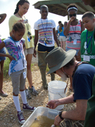 A volunteer tells students about what they caught.