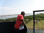 A students looking out at the Houston Ship Channel from an upper deck of Battelship Texas.
