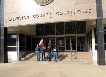Buffalo soldier re-enactors standing in front of the Galveston County Courthouse steps.