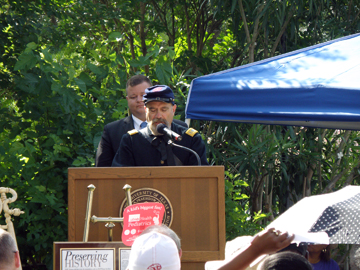 An actor dressed as a Union soldier reads aloud the Emancipation Proclamation from a podium.