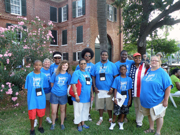 Group of NABS YES participants dressed in matching t-shirts and standing with Geraldine Sams.