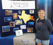 Kelly Drinnen wearing a red hat by a sanctuary display.