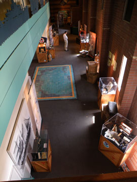 Looking down on a museum exhibit area from the second floor.