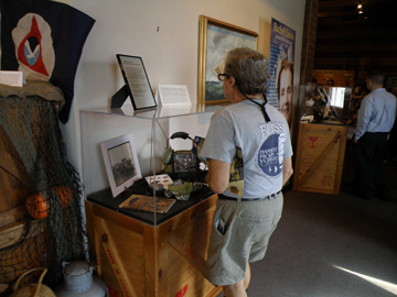 A guest views a display case of information about sea turtle research.