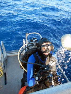 Diver using a shower rinse on the dive platform