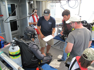 Divers gathered together for a briefing before the dive.