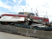 Two large boats smashed together against a concrete barrier alongside the highway entering Galveston.