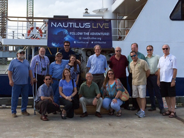 Group photo of council and staff members in front of E/V NAUTILUS at the dock in Galveston