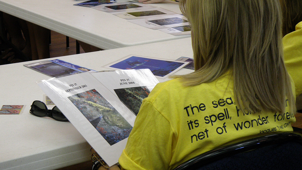 Camp participants looking at reef monitoring images as part of an activity