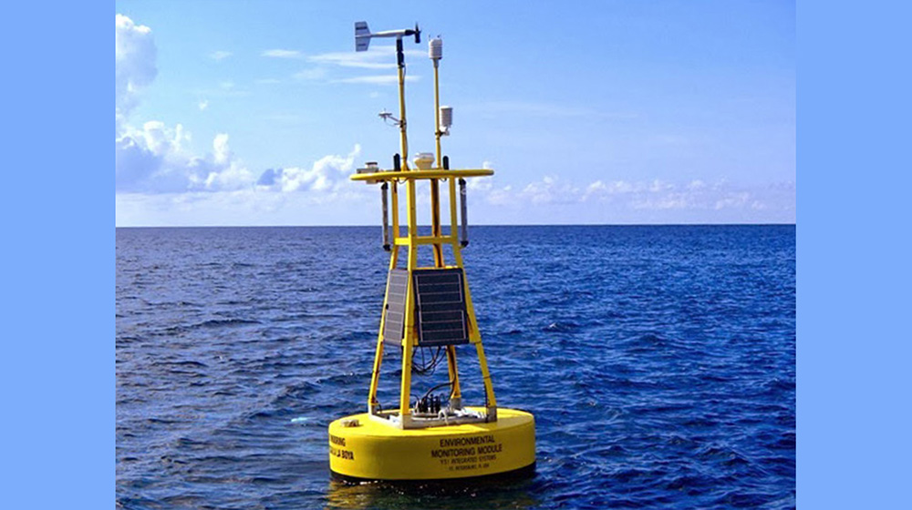 Yellow data buoy floating on calm seas