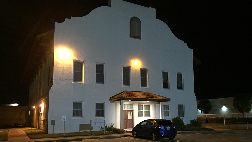 Night view of mission-style building that houses sanctuary offices
